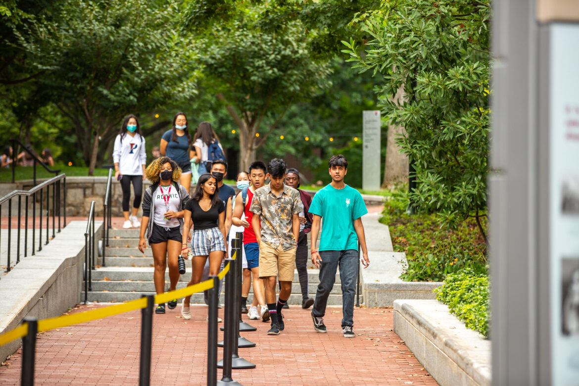 Students walking on Locust Walk near College Hall