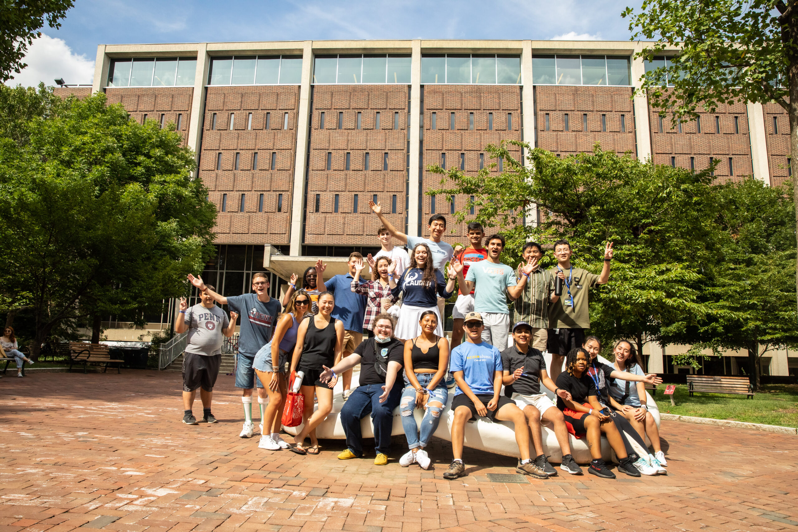 Students sitting/gathering around the Button outside of Van Pelt libray