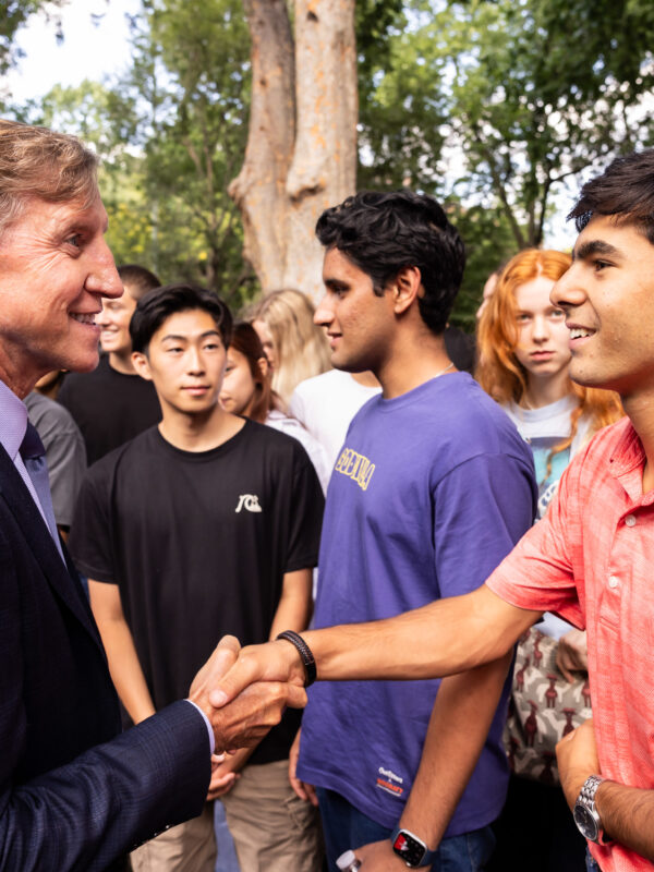 Penn Interim President shaking hands with Penn student